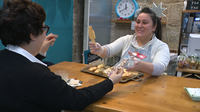 Lidia intercambia unha galleta por un adorno que lle levou unha clienta