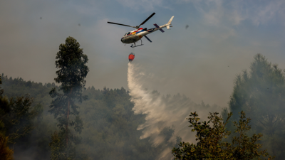 Un helicoptero bota auga sobre o incendio de Castro Daire (Reuters / Pedro Nunes)